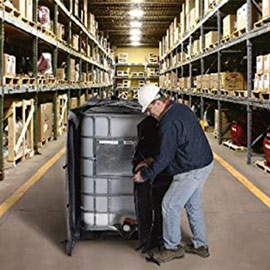 Man wrapping an IBC tote heater around a tote