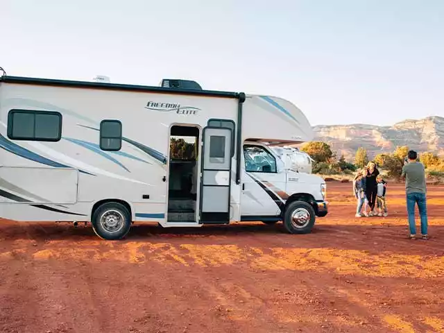 man taking a photo next to rv